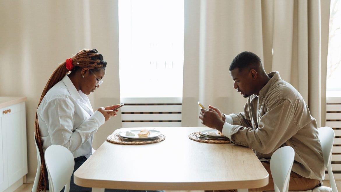 Two people sitting across from each other at a table